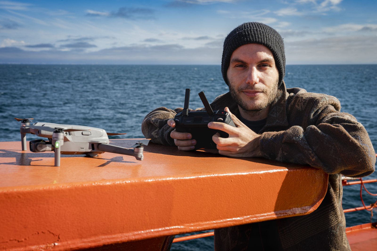 Elven Villecourt on a ship’s deck with a drone and its controller.