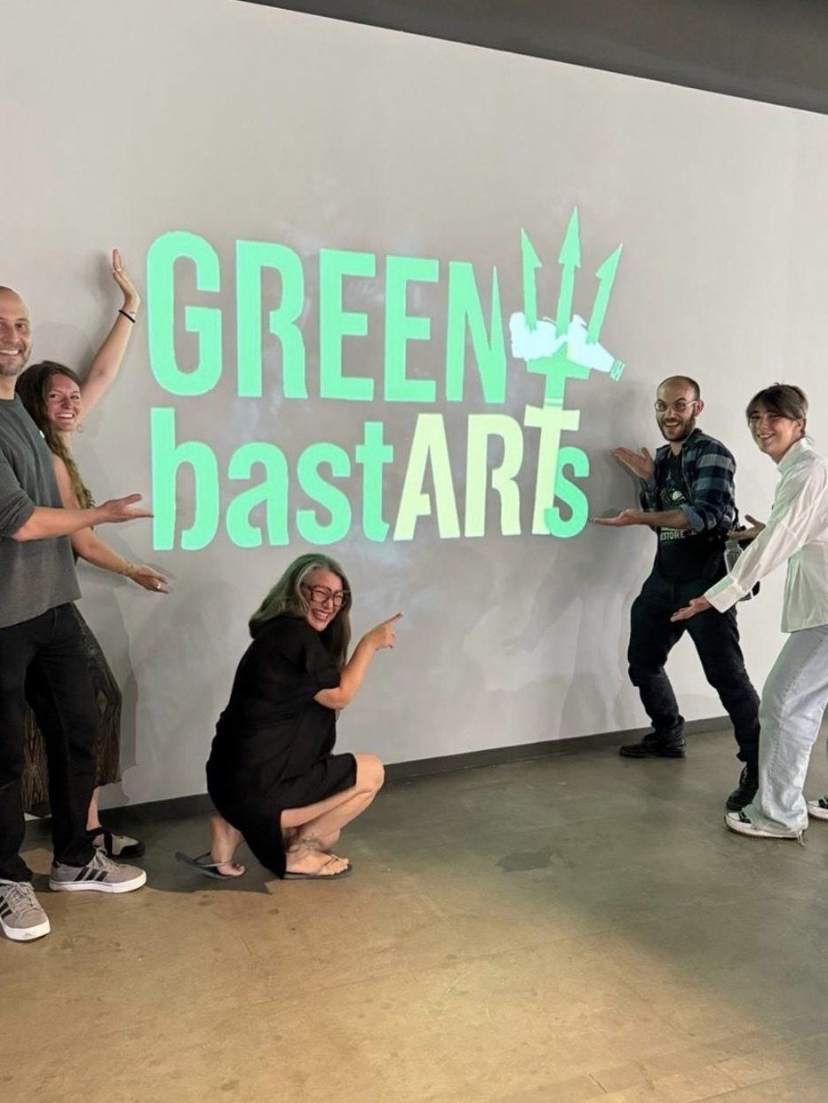 The collective in front of the GREENy bastARTs wall lettering.